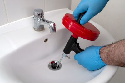 Plumber Using a Drain Snake